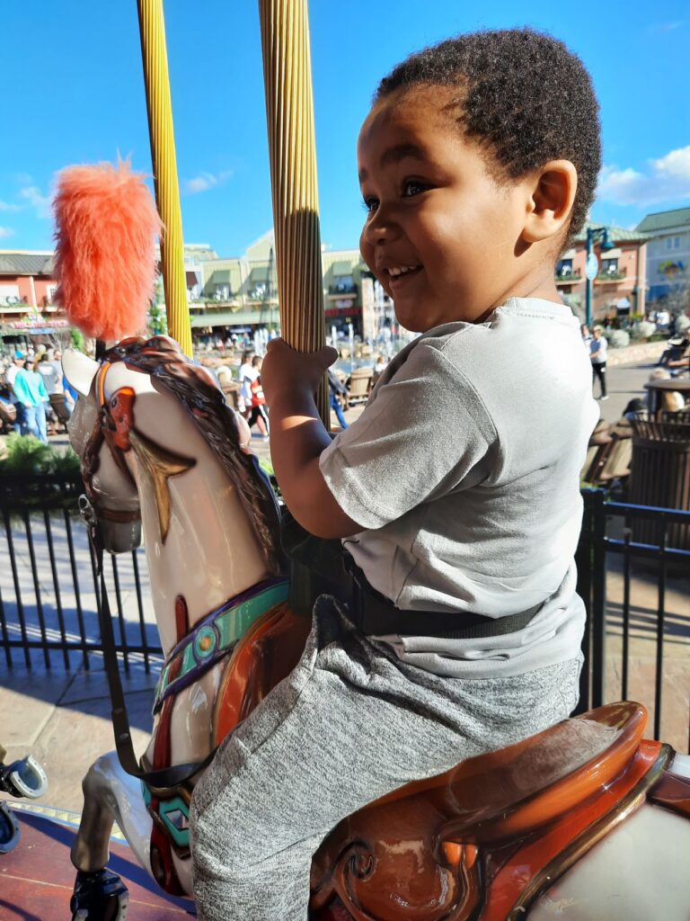child riding the carousel at the island in pigeon forge tennessee